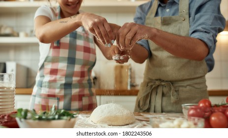 Cropped Shot Of Couple Preparing The Dough Together. Young Man And Woman In Apron Cooking, Making Pizza At Home. Hobby, Lifestyle. Focus On Hands. Web Banner