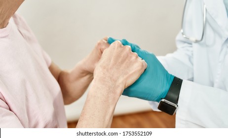 Cropped Shot Of A Doctor In Blue Sterile Gloves Holding Hands Of Female Senior Patient. Main Focus On Hands. Close Up. Healthcare. Hospital. Medical Ethics. Medical Care, Support. Medical Banner