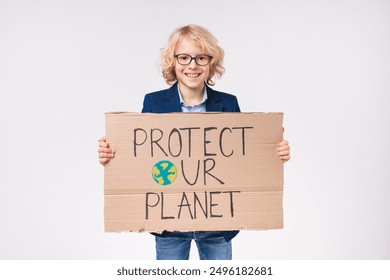 Cropped shot of an eco-friendly caucasian little small preteen boy male child kid elementary primary middle school pupil teenager holding poster for saving the planet isolated over white background - Powered by Shutterstock