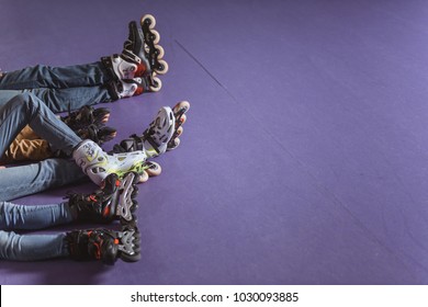 cropped shot of family resting on roller rink after skating