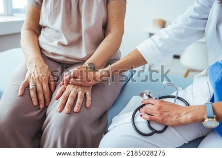 Cropped shot of a female doctor hold her senior patient's hand. Giving Support. Doctor helping old patient with Alzheimer's disease. Female carer holding hands of senior woman.