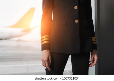 cropped shot of female pilot in professional uniform