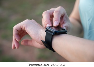 Cropped Shot Of Female Runner Checking Health Status And Fitness Progress On Her Smart Watch.