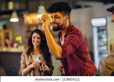 Cropped Shot Of Friends Playing Darts