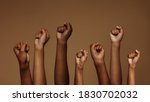 Cropped shot of hands raised with closed fists. Multiple hands raised up with closed fist symbolizing the black lives matter movement.