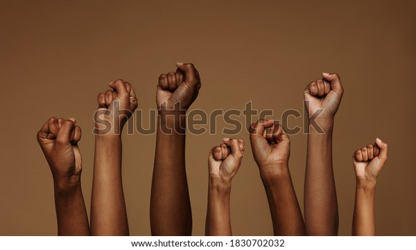 Cropped shot of hands raised with closed fists.\
Multiple hands raised up with closed fist symbolizing the black\
lives matter movement.