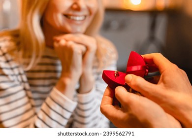 Cropped shot of happy caucasian woman being proposed by her boyfriend during romantic date. Diamond ring, engagement, she said yes concept. New family start - Powered by Shutterstock