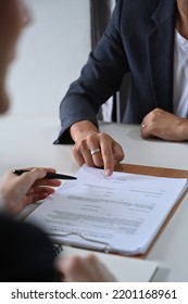 Cropped shot of male lawyer providing law consultation and legal advice to client and showing place for signature on contract document - Shutterstock ID 2201168961