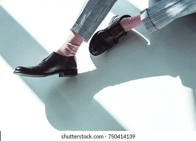 Cropped Shot Of Male Legs In Leather Shoes And Pink Socks