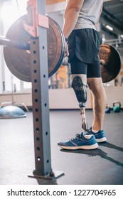 Cropped Shot Of Man With Artificial Leg Working Out With Barbell At Gym