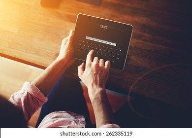 Cropped Shot Of A Man's Hands Using A Digital Tablet At Office, On-line Shopping At Home, Cross Process, Filtered Image, Flare Sun Light, Data Security