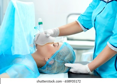 Cropped shot of a nurse holding oxygen mask for a female patient during surgery healthcare living profession help assistance health operation medicine clinic treatment concept. - Powered by Shutterstock