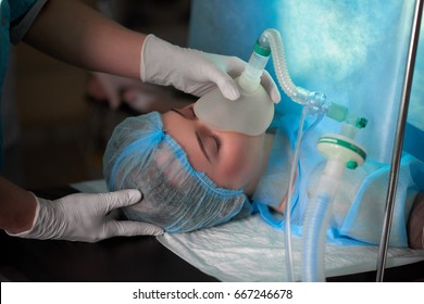 Cropped shot of a nurse holding oxygen mask on a female patient during surgery medicine healthcare professionalism help concept.