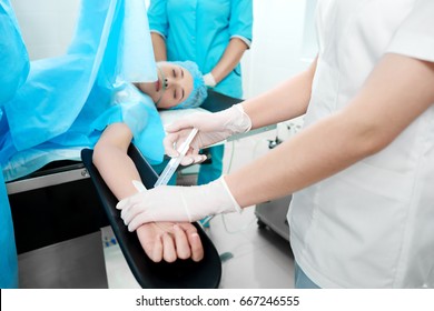 Cropped shot of a nurse making an injection to a female patient during surgery medicine people profession occupation job professionalism health concept.
