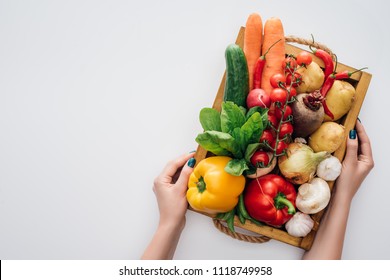 cropped shot of person holding box with fresh ripe organic vegetables isolated on white 