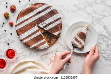 cropped shot of person putting piece of delicious homemade cake on plate  - Shutterstock ID 1126832657