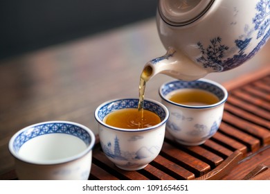 Cropped shot of pouring tea in traditional chinese teaware.