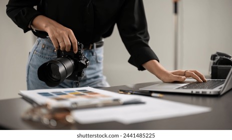 A cropped shot of a professional female photographer checking images on a laptop computer in a studio. photoshoot, photography - Powered by Shutterstock