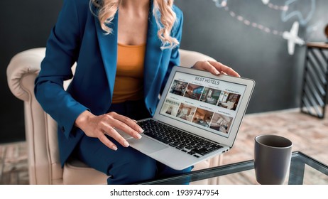 Cropped shot of professional female travel agent using laptop while offering tours to her clients in office. Tourism, travelling, business concept. Web Banner