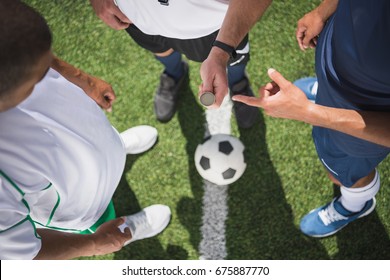 Cropped Shot Of Referee Holding Coin Before Start Of Soccer Match On Pitch