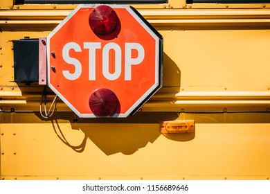 Cropped Shot Of School Bus With Stop Sign