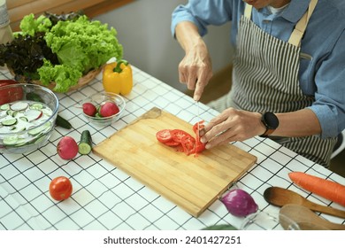 Cropped shot of senior man preparing ingredients for making healthy vegan salad in the kitchen - Powered by Shutterstock