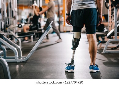 Cropped Shot Of Of Sportsman With Artificial Leg Standing At Gym