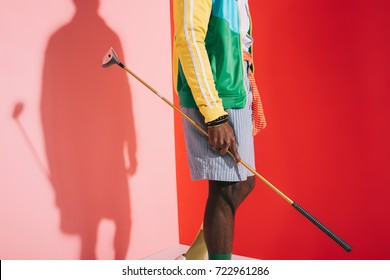 cropped shot of stylish african american man holding golf club  - Shutterstock ID 722961286