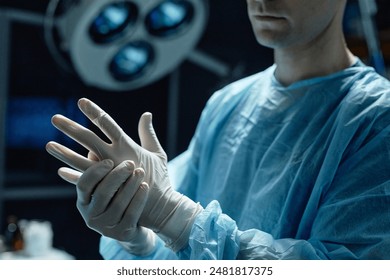 Cropped shot of surgeon wearing protective gloves preparing for surgery in operating room copy space - Powered by Shutterstock