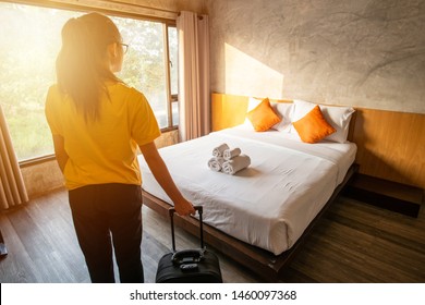 Cropped shot of tourist woman pulling her luggage to her hotel bedroom after check-in. Conceptual of travel and vacation. - Shutterstock ID 1460097368
