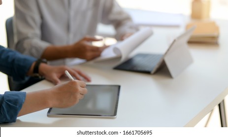 Cropped Shot Of Two Businessman Working With Digital Tablet And Document File On White Table In Glass Wall Office Room