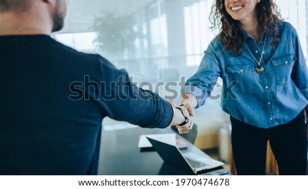 Cropped shot of a two businesspeople handshake after successful meeting. Businesswoman shaking hands with job candidate.