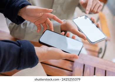 A cropped shot of two people sharing contact info or transferring files by bringing two smartphones close together. people and modern technology concepts - Powered by Shutterstock