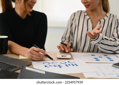 Cropped shot of two professionals businesswomen analyzing marketing research reports together at office desk - Shutterstock ID 2254957939