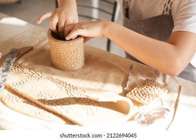 Cropped shot of unrecognizable child making ceramic mug at pottery class - Shutterstock ID 2122694045
