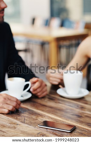 Cropped shot of an unrecognizable couple out on a date at a coffee shop