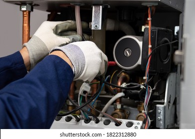 Cropped Shot Of An Unrecognizable Male Boiler Technician Repairing A Water Pump Stuck Inside A House