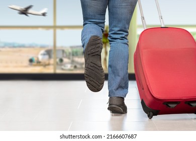 Cropped shot of an unrecognizable man running at the airport at last minute for immediate departure of his plane - Shutterstock ID 2166607687