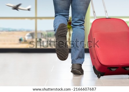 Cropped shot of an unrecognizable man running at the airport at last minute for immediate departure of his plane