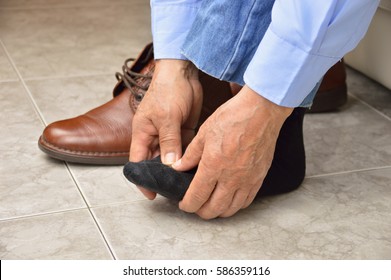 Cropped Shot Of An Unrecognizable Man Suffering With Foot Cramp In The Room