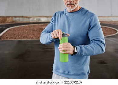 Cropped Shot Of Unrecognizable Senior Man Holding Water Bottle During Outdoor Workout In Urban Setting, Copy Space