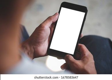 Cropped Shot View Of Man Hands Holding Smart Phone With Blank Copy Space Screen For Your Text Message Or Information Content, Female Reading Text Message On Cell Telephone During In Urban Setting.