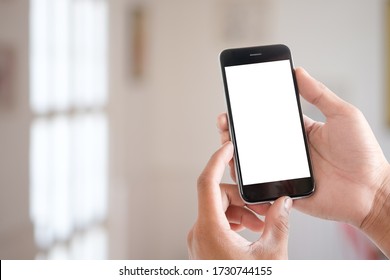 Cropped shot view of man hands holding smart phone with blank copy space screen for your text message or information content, female reading text message on cell telephone during in urban setting.  - Shutterstock ID 1730744155