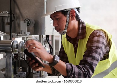 Cropped shot view Manager Technical Industrial Engineer working and control robotics with monitoring system software and industry network connection on tablet.