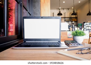 Cropped shot view of white office desk table with the office equipments, alcohol sanitizer, face mask and other office supplies on the modern space, flat lay.work at home. - Shutterstock ID 1924818626