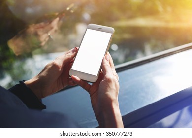 Cropped Shot View Of A Woman's Hands Holding Mobile Phone With Empty Copy Space Screen For Your Text Message Or Advertising Content, Young Female Person Chatting On Cell Telephone During Work Break 