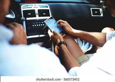 Cropped Shot View Of A Young Man Using Navigation On Mobile Phone While Sitting On Front Seat In Luxury Car Cabriolet, Male Viewing Location Map In Network Via Cell Telephone During Road Trip 