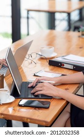 Cropped Shot Of Woman Hand Typing On Tablet Keyboard While Sitting At Office Desk, Vertical View.