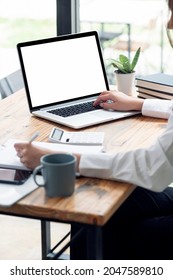 Cropped Shot Of Woman Hand Working On Laptop Computer At Office, Mockup Blank Screen Laptop For Product Display, Vertical View,