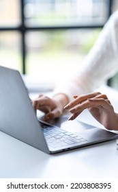 Cropped Shot Of Woman Hands Typing On Laptop Keyboard At The Office.